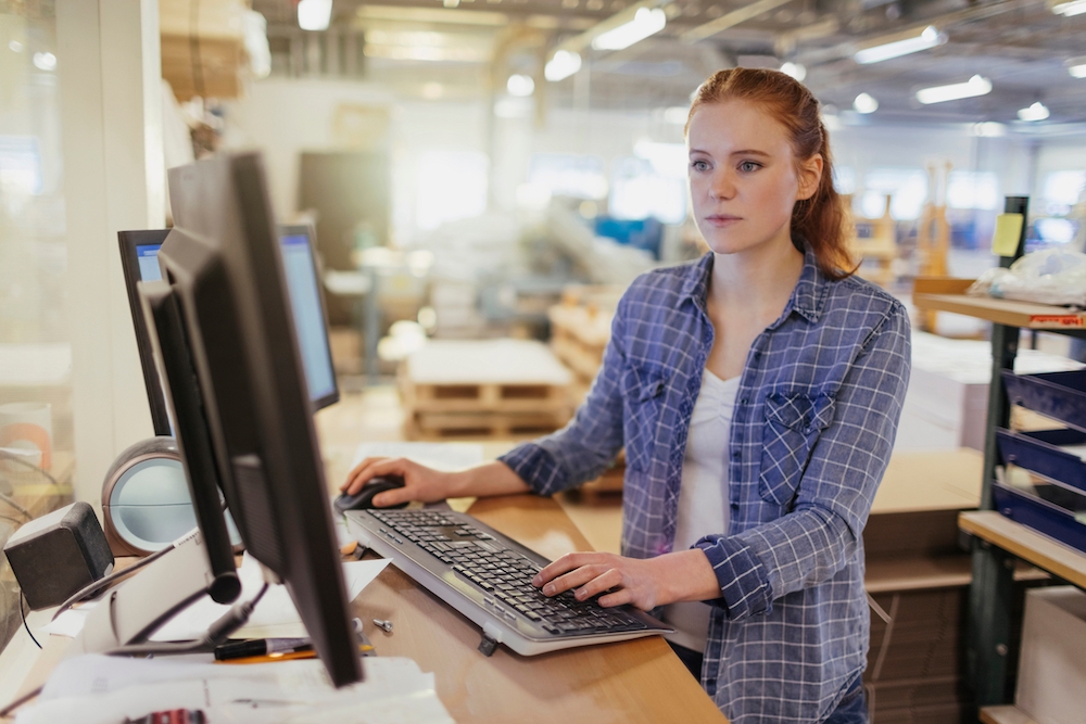Production operator managing print jobs with integrated RIP software