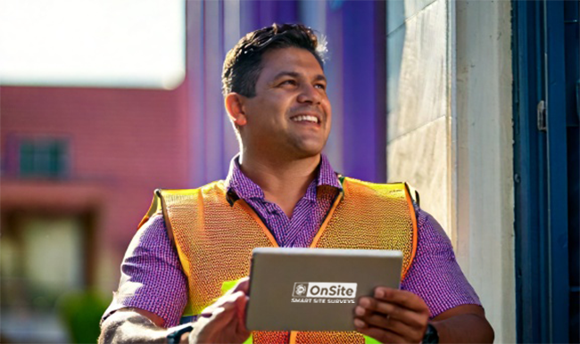 A man is happy because he is using SAi OnSite for site surveys for sign installation.